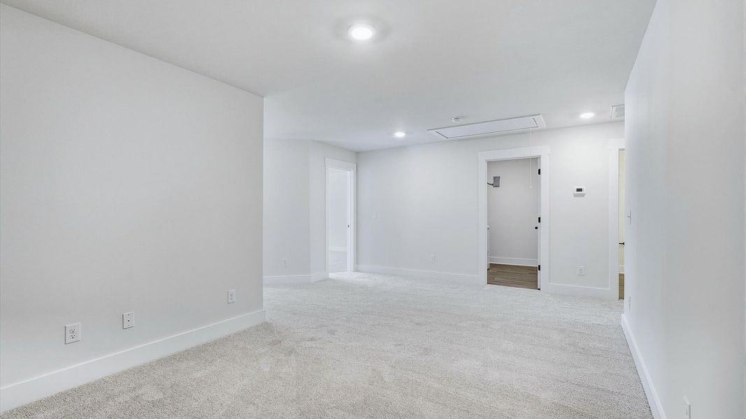 Elegant, carpeted loft that adds a superior layer of flexibility to the home’s design by DRB Homes
