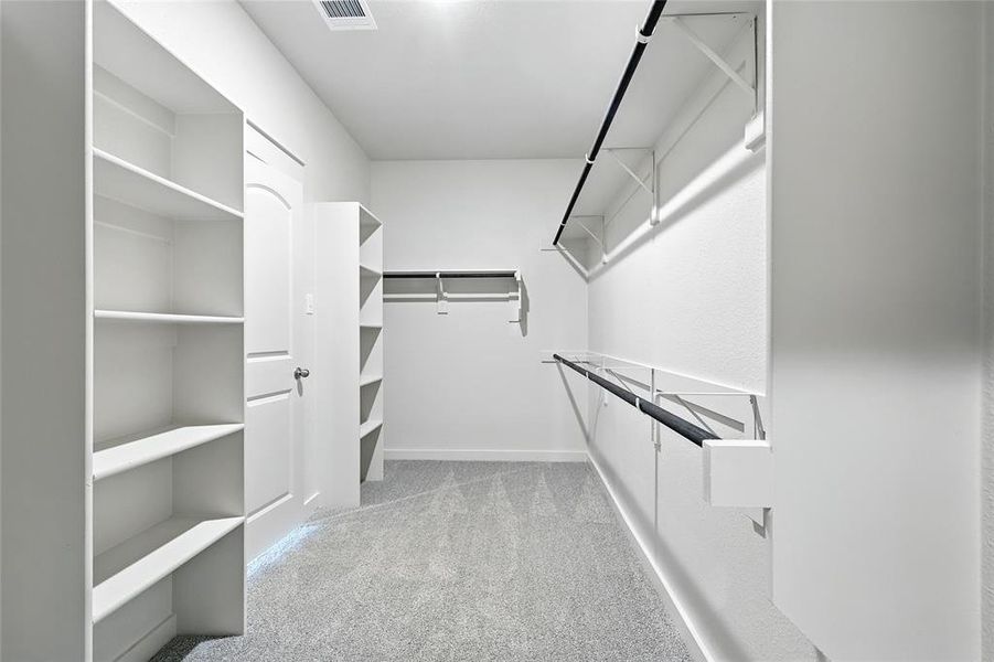 Walk in closet with light colored carpet Walk in closet with light colored carpet