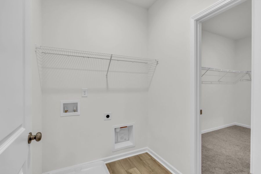 Laundry room with access to the primary walk-in closet. Laundry room with access to the primary walk-in closet.