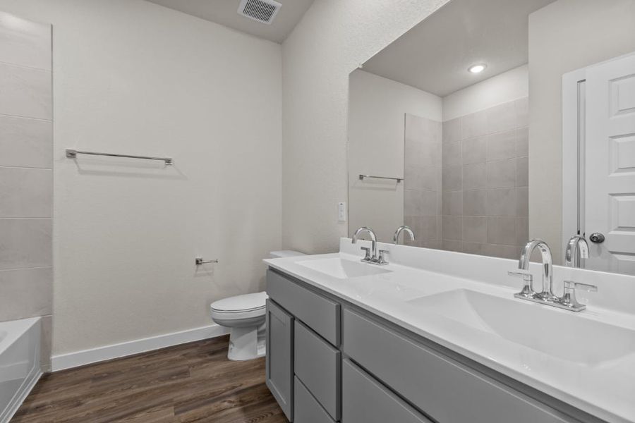 A bathroom with a large mirror. A bathroom with a large mirror.