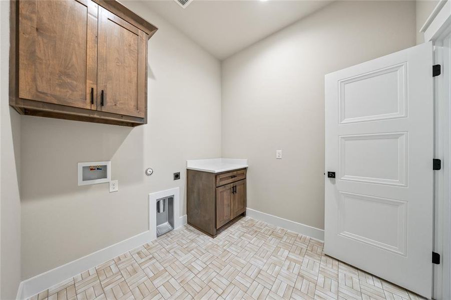 Washroom with cabinet space, gas dryer hookup, washer hookup, and hookup for an electric dryer