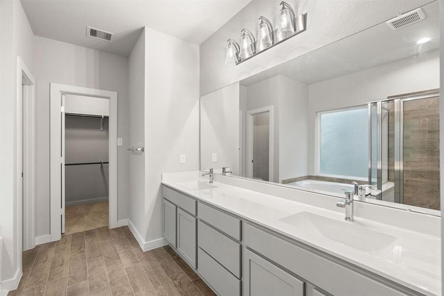 Luxurious primary bath retreat within the confines of your main bathroom. Sample photo of completed home with similar floor plan. As-built interior colors and selections may vary.