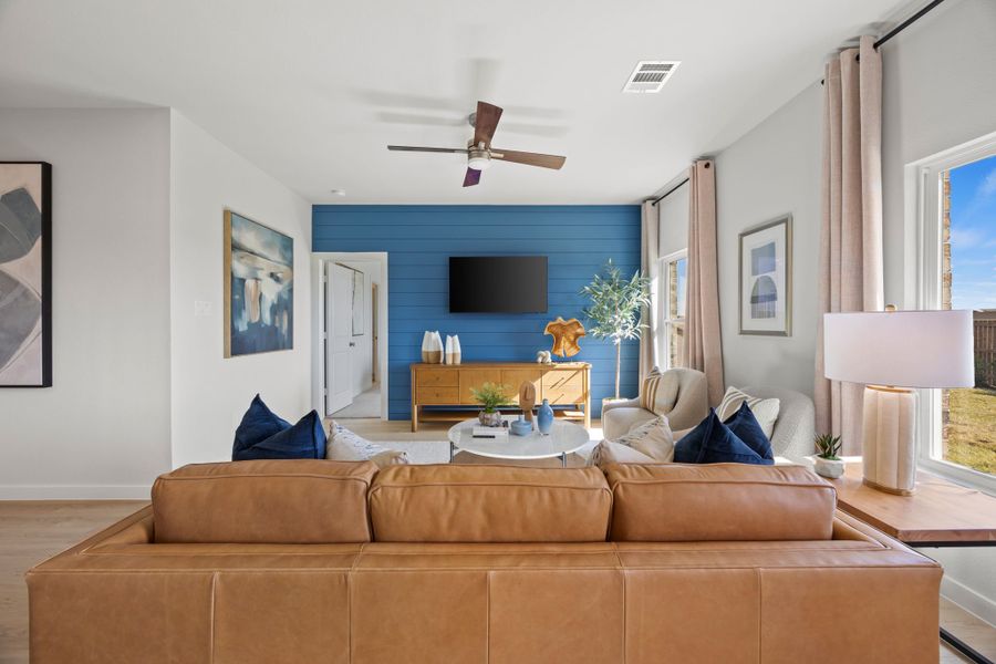 A living room with a couch and a tv. A living room with a couch and a tv.