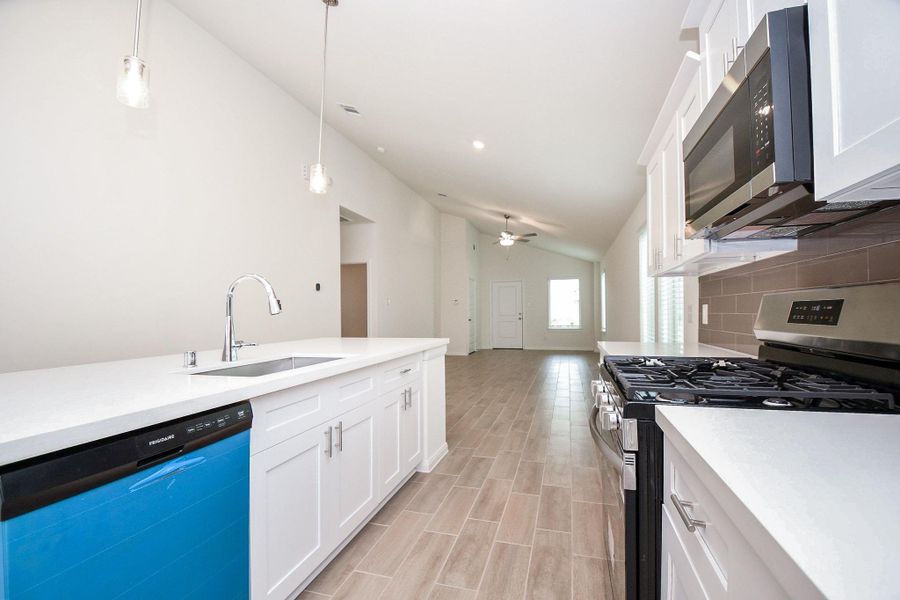 The expansive quartz countertops allow plenty of space for meal preparation. The beautiful island offers more available seating to enjoy delicious meals.