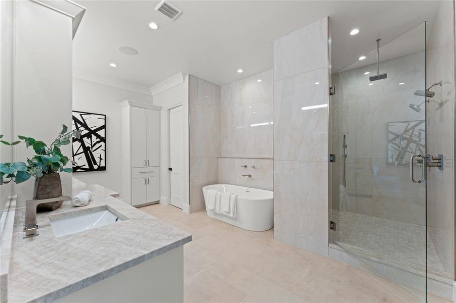 Serene primary bath with honed Taj Mahal quartzite stone countertops