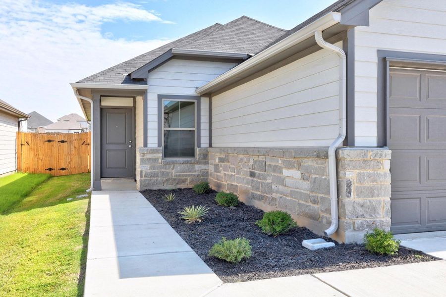 Front exterior of a new home in Trinity Ranch, Elgin, TX, highlighting curb appeal (Image 22).