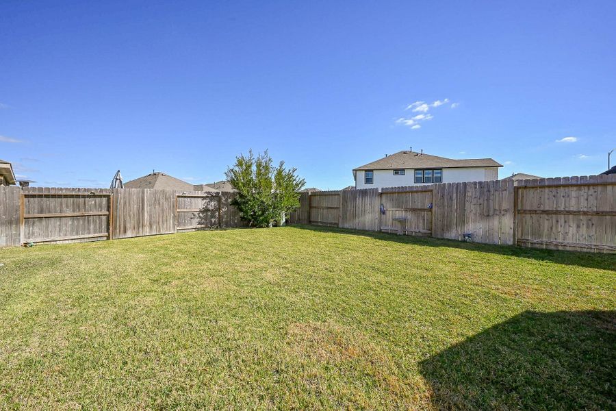 A peaceful outdoor retreat framed by a full wooden privacy fence, ideal for relaxation, play, or gardening. A peaceful outdoor retreat framed by a full wooden privacy fence, ideal for relaxation, play, or gardening.