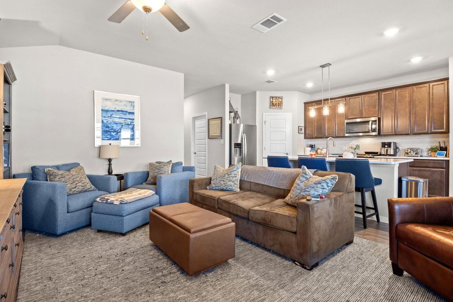 Living room featuring recessed lighting, a ceiling fan, and light wood finished floors Living room featuring recessed lighting, a ceiling fan, and light wood finished floors