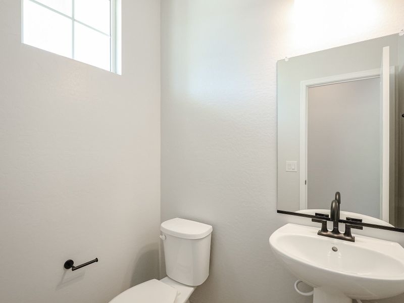 A bathroom with a toilet and sink. A bathroom with a toilet and sink.