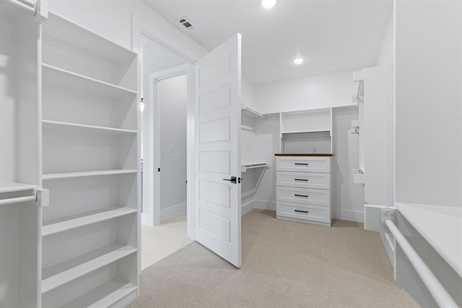 Primary Suite Walk-In Closet with Two Dressers, Shoe Storage & Laundry/Mud Room Direct Access