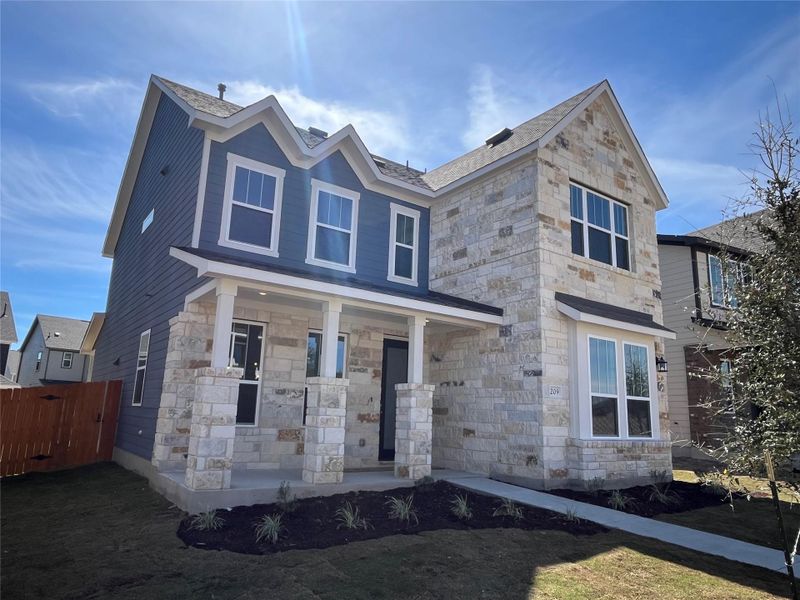 Front exterior of a new home in Lariat, Liberty Hill, TX, highlighting curb appeal (Image 20).
