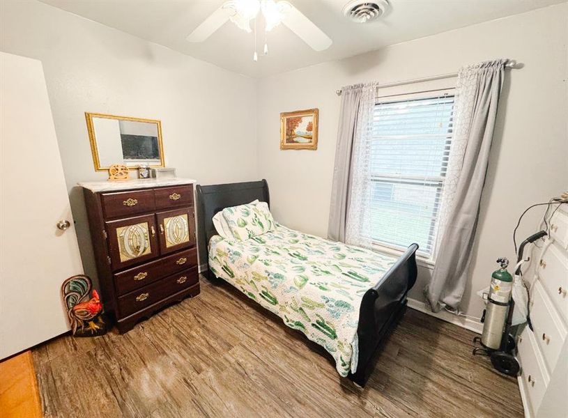 Bedroom featuring wood finished floors and a ceiling fan