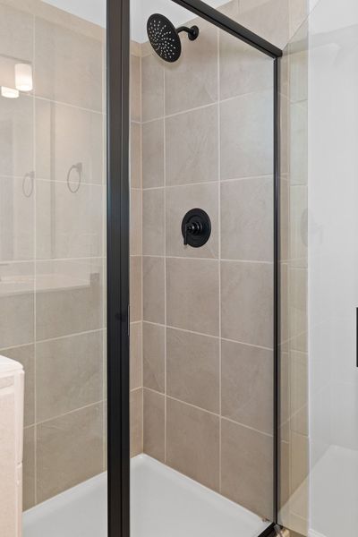 A shower with a glass door. A shower with a glass door.