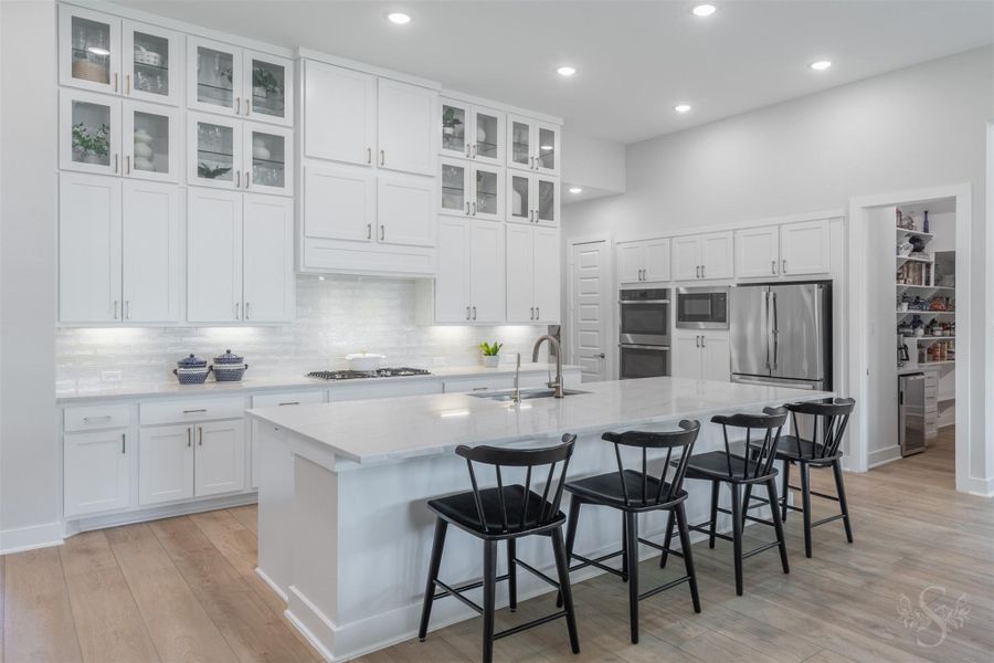 The expansive quartz island provides an incredible amount of room for meal preparation, serving and gathering. The breakfast bar makes it a natural centerpiece for everyday living and entertaining. The expansive quartz island provides an incredible amount of room for meal preparation, serving and gathering. The breakfast bar makes it a natural centerpiece for everyday living and entertaining.