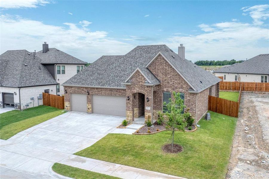 View of front of home featuring a chimney, an attached garage, brick siding, driveway, and a shingled roof View of front of home featuring a chimney, an attached garage, brick siding, driveway, and a shingled roof