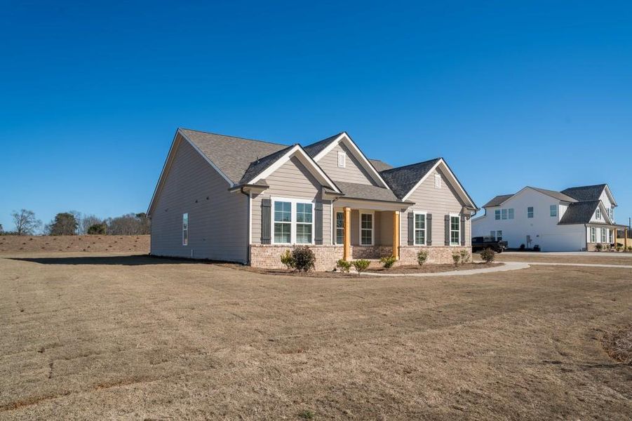 Front exterior of a new home in Magnolia Ridge, Monroe, GA, highlighting curb appeal (Image 21).