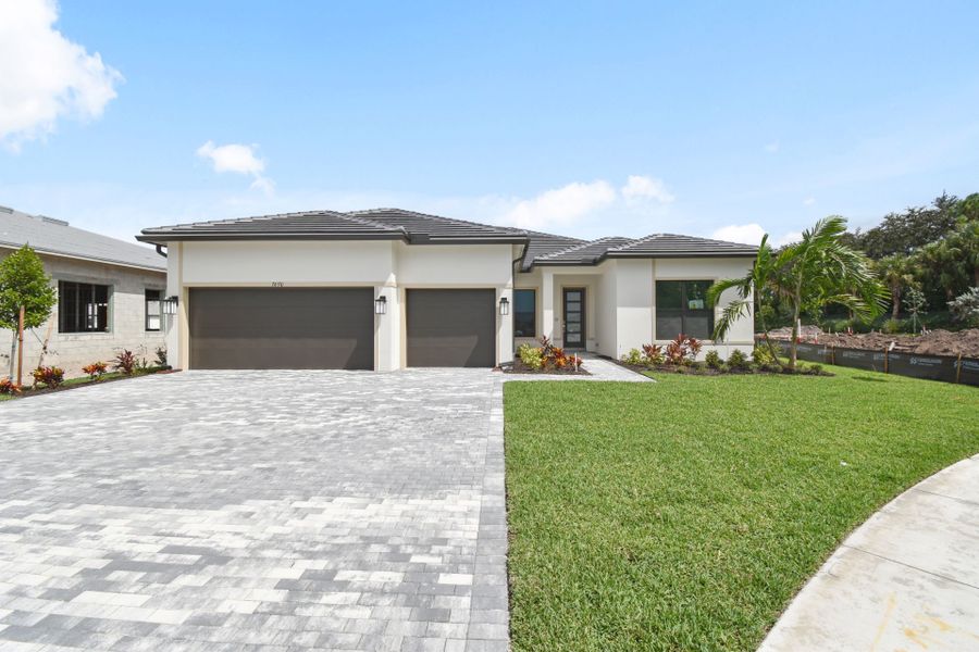 Front exterior of a new home in Greyhawk Landing, Lake Worth, FL, highlighting curb appeal (Image 2).