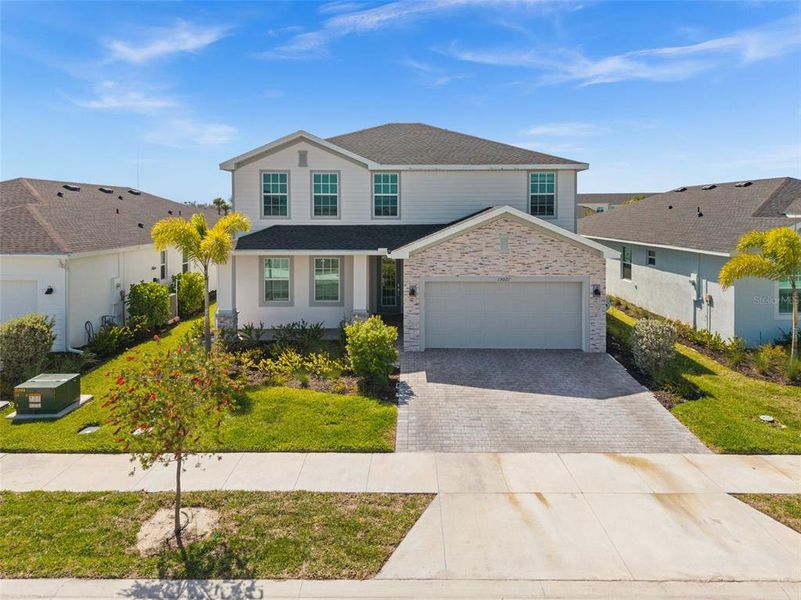 Front exterior of a new home in Tuckers Cove, Punta Gorda, FL, highlighting curb appeal (Image 2).