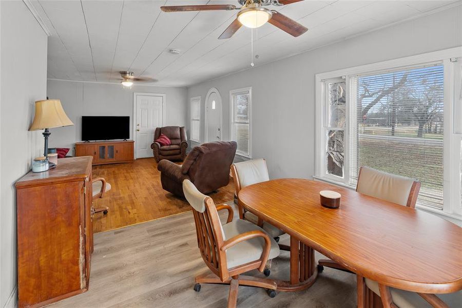 Dining area with ceiling fan and light hardwood / wood-style floors