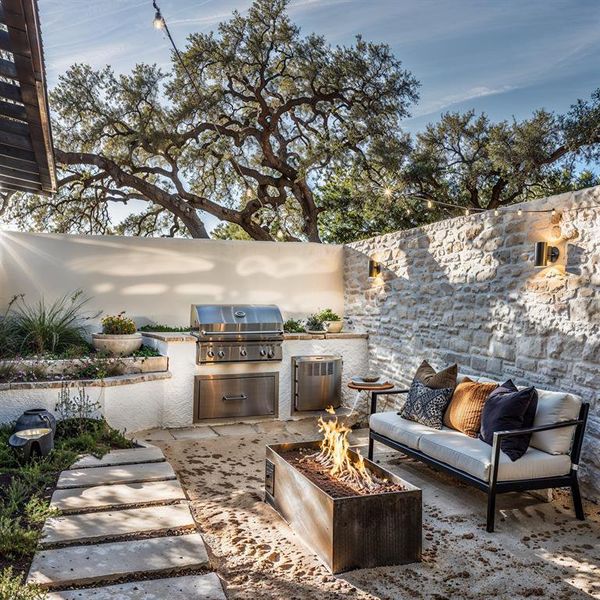 View of patio / terrace featuring area for grilling, an outdoor kitchen, and an outdoor fire pit