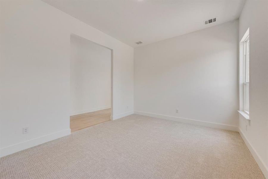 Unfurnished room featuring light carpet and baseboards Unfurnished room featuring light carpet and baseboards