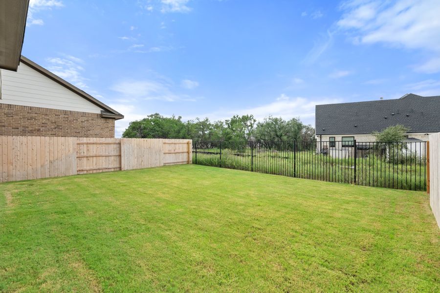 Exterior details and patio area of a home in Lariat, Liberty Hill (Image 29).