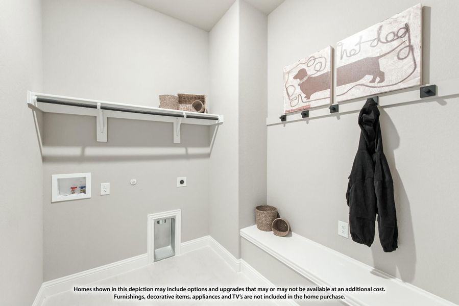 Laundry and mudroom area with wall shelf, coat hooks, bench, and built-in pet door Laundry and mudroom area with wall shelf, coat hooks, bench, and built-in pet door