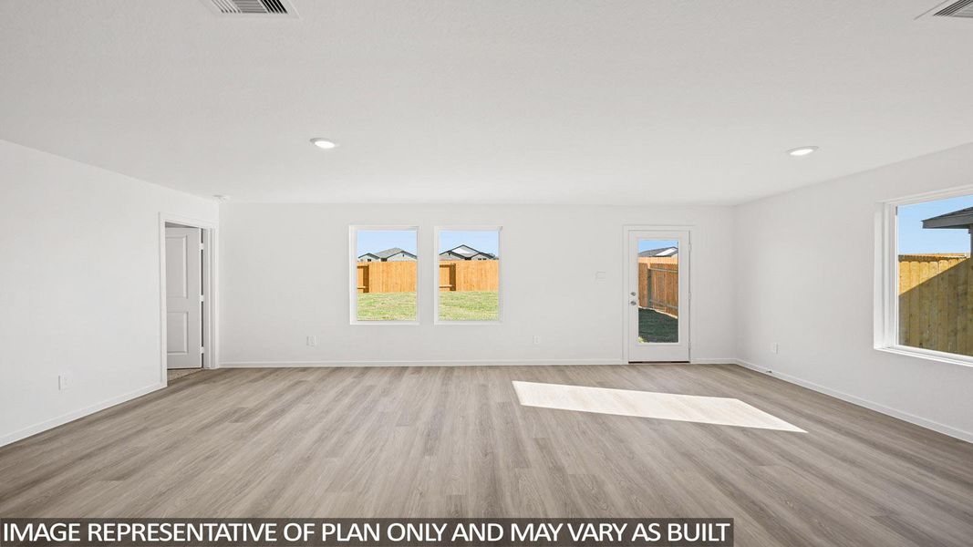 Empty room featuring light wood-style floors and recessed lighting