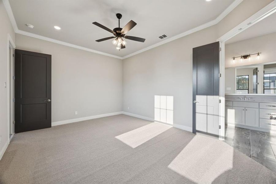 Large bedroom with double doors to primary bathroom.