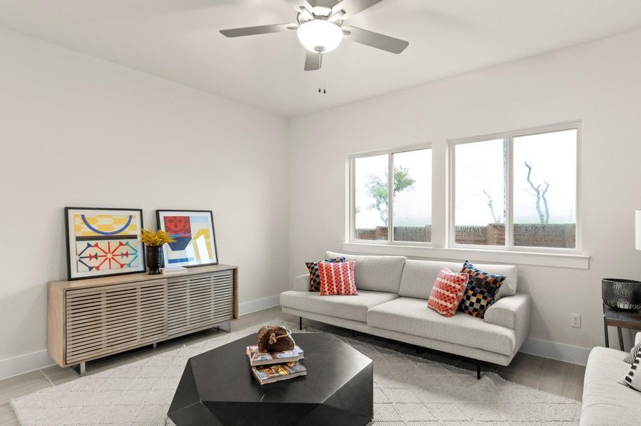 Natural light floods this inviting living space, complete with sleek modern flooring and a comfortable sofa.