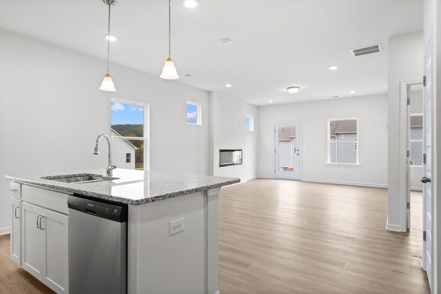 The Dove- Kitchen into the Family Room. Home under construction, photo used for illustrative purposes only, colors and options will vary.
