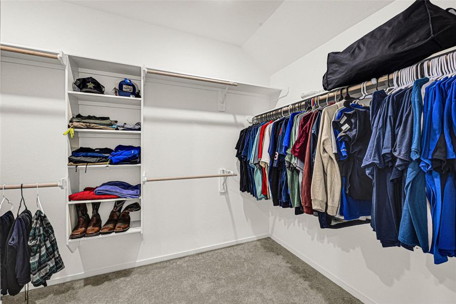 Spacious walk-in closet with ample shelving and hanging space, perfect for organizing clothes and accessories. Spacious walk-in closet with ample shelving and hanging space, perfect for organizing clothes and accessories.