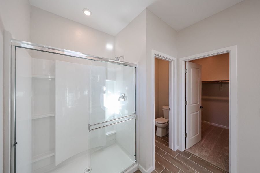 A bathroom with a glass shower. A bathroom with a glass shower.