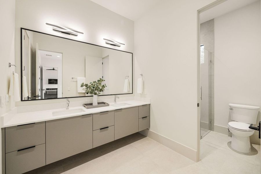 [SECONDARY BATHROOM]  Stylish secondary bath with large vanity, two sinks and ample storage, walk-in shower. Shared between two secondary bedrooms.