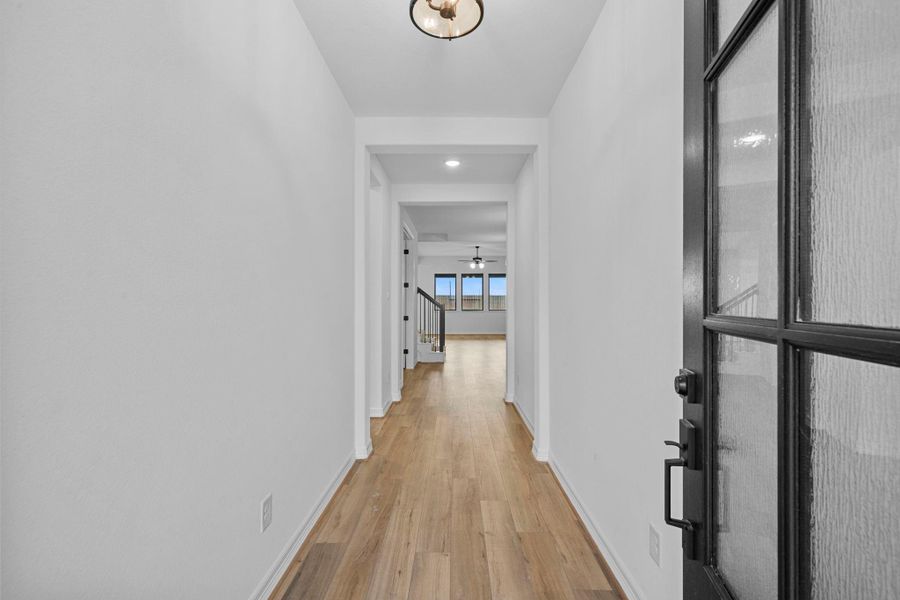 The foyer welcomes you home with natural textures, soft light, and timeless farmhouse appeal.