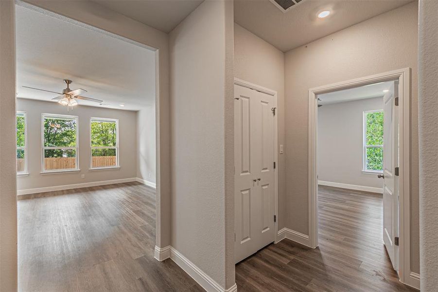 Hall with dark hardwood / wood-style flooring