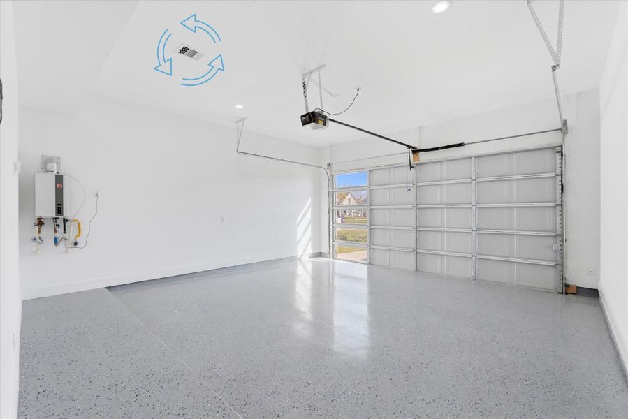 Attached garage equipped with a garage door opener, epoxy flooring, central A/C components, and a gas tankless water heater for added efficiency and convenience.