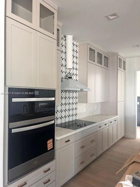 stacked cabinets, quartz uartz with waterfall on island