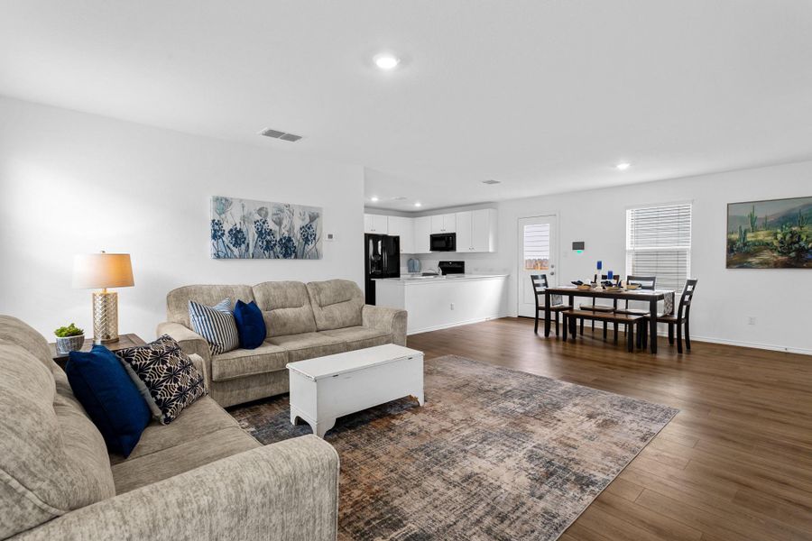 Spacious interior featuring wood-finish flooring, white walls, and recessed lighting