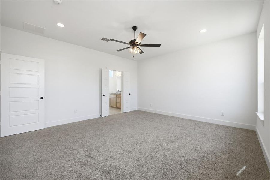 Unfurnished bedroom with carpet floors, recessed lighting, a ceiling fan, and connected bathroom Unfurnished bedroom with carpet floors, recessed lighting, a ceiling fan, and connected bathroom
