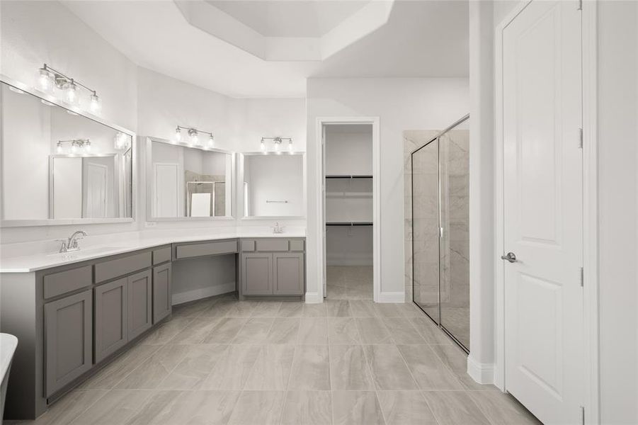 Bathroom with a shower stall, double vanity, and a walk in closet Bathroom with a shower stall, double vanity, and a walk in closet