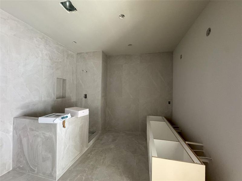 primary bathroom with ultra luxury porcelain tile throughout the flooring and walls