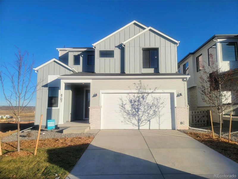 Front exterior of a new home in , Littleton, CO, highlighting curb appeal (Image 1).