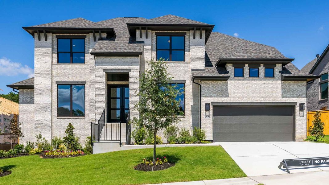 Front exterior of a new home in Palmera Ridge, Leander, TX, highlighting curb appeal (Image 2). Front exterior of a new home in Palmera Ridge, Leander, TX, highlighting curb appeal (Image 2).