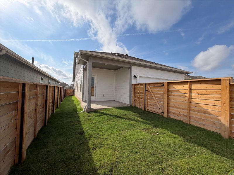 Rear view of property featuring a fenced backyard and a patio area