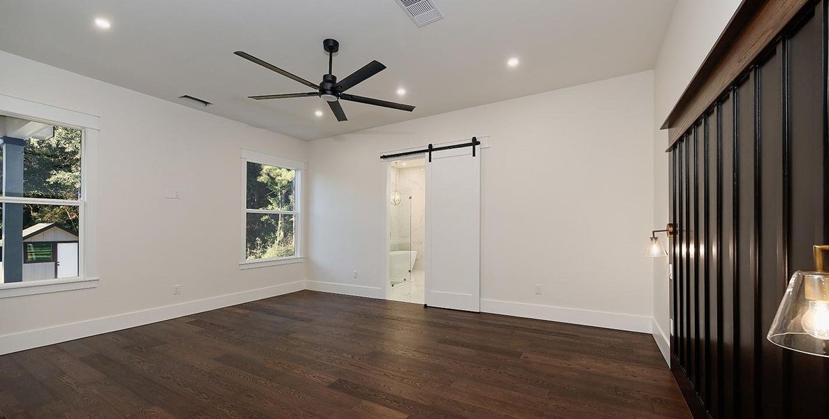 Main Floor Primary Retreat with Sliding Bathroom Entry Overlooking the Backyard Main Floor Primary Retreat with Sliding Bathroom Entry Overlooking the Backyard