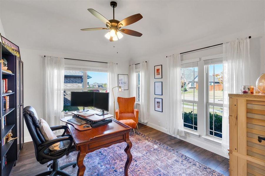 Office with ceiling fan, a healthy amount of sunlight, and dark hardwood / wood-style floors