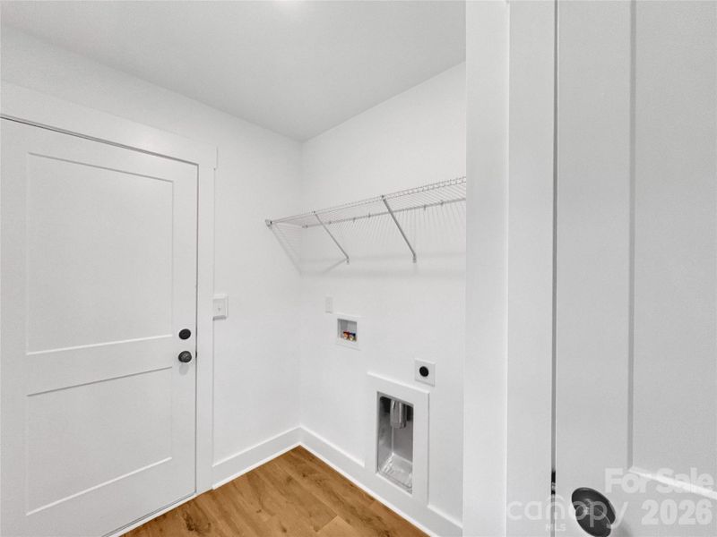 Laundry area in the mudroom by the garage entrance Laundry area in the mudroom by the garage entrance