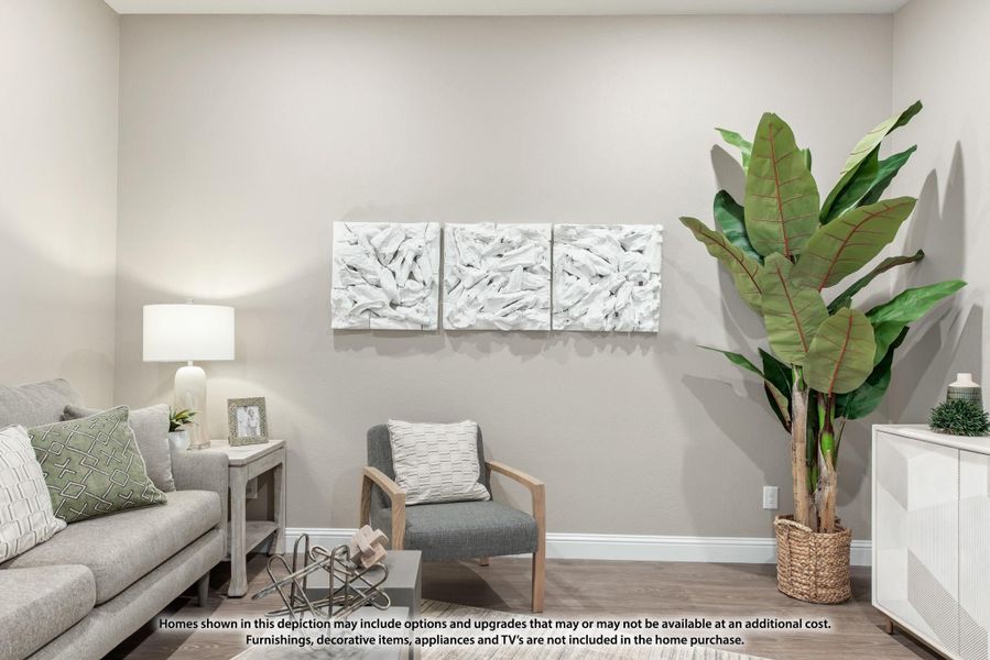 Living room with gray sofa, accent chair, white wall art panels, and large potted plant on hardwood floors Living room with gray sofa, accent chair, white wall art panels, and large potted plant on hardwood floors