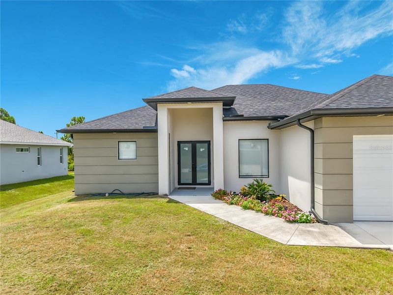 Front exterior of a new home in , Lehigh Acres, FL, highlighting curb appeal (Image 2). Front exterior of a new home in , Lehigh Acres, FL, highlighting curb appeal (Image 2).